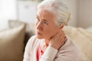 senior woman looking worried - suffering from neck pain