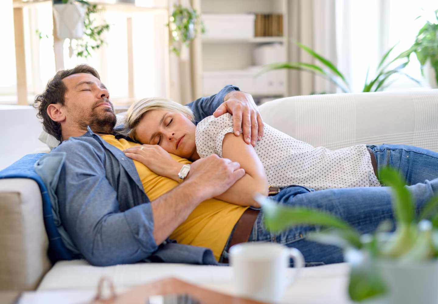 adult couple napping on a couch