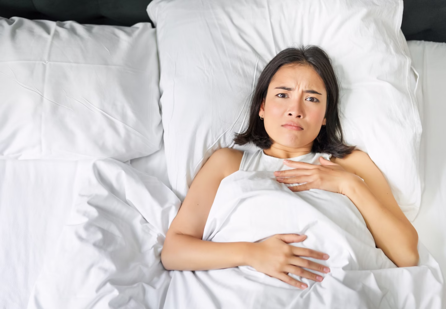 portrait-of-young-asian-woman-lying-in-bed-with-gerd