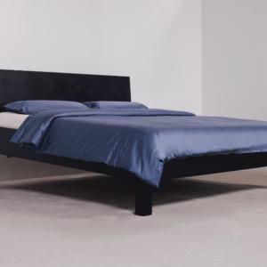 blue bedding on black bed frame